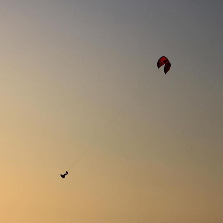 Beach Photograph - Kitesurfer On The Beach During Sundown by Niclas Holtmann