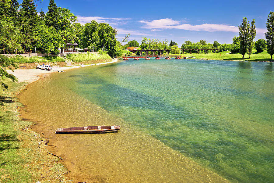 Korana river beach and wooden boat Photograph by Brch Photography