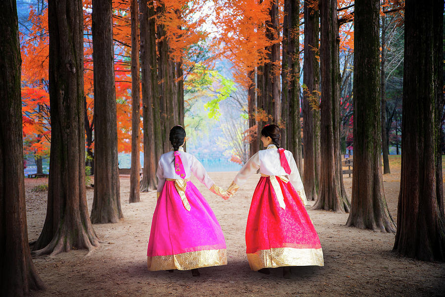 Korean girl walking in nami park in nami island Photograph by Anek Suwannaphoom