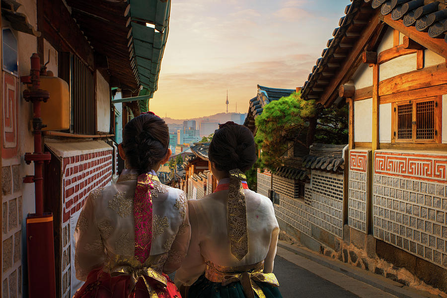 Korean lady in Hanbok and walk in an ancient town Photograph by Anek Suwannaphoom