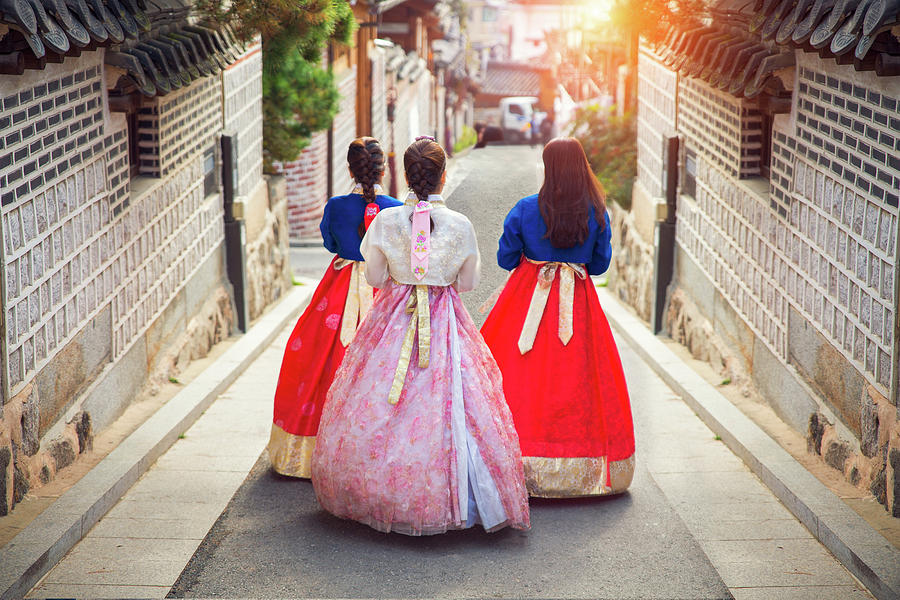 Korean lady in Hanbok walk in an ancient town Photograph by Anek Suwannaphoom
