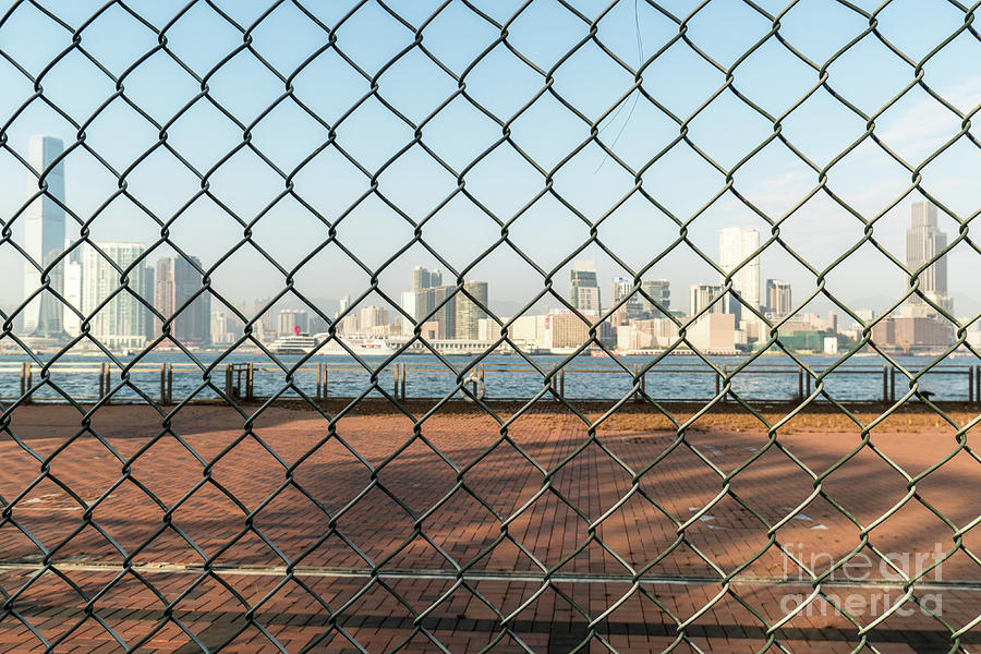 Kowloon skyline view through a fence in Hong Kong Photograph by Didier Marti