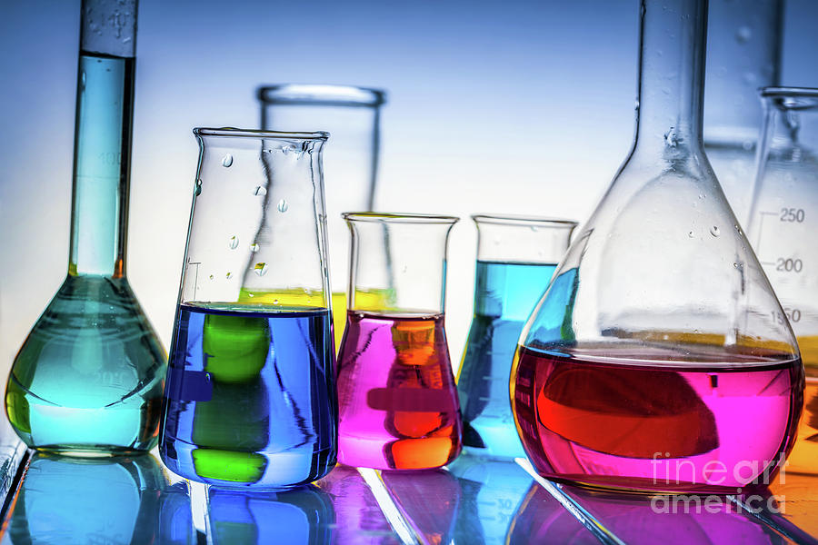 Laboratory glass filled with chemical liquids. Photograph by Michal Bednarek
