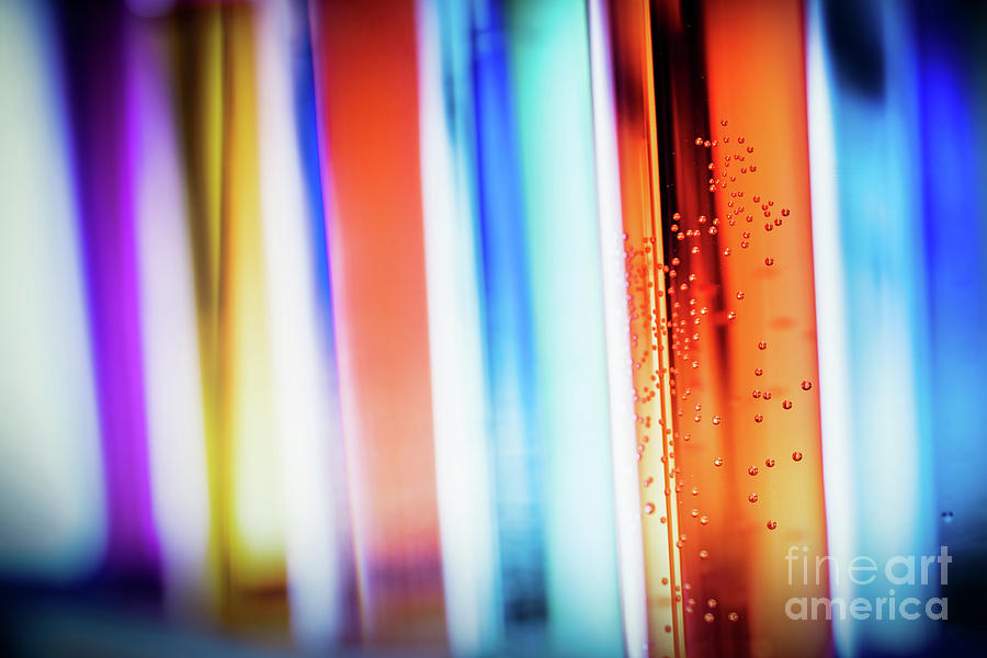 Laboratory glass filled with colorful substances. Photograph by Michal Bednarek
