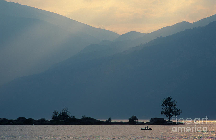 Lake Garda Photograph - Lake Garda dusk with fisherman by Damian Davies Lake Garda Photograph - Lake Garda dusk with fisherman by Damian Davies