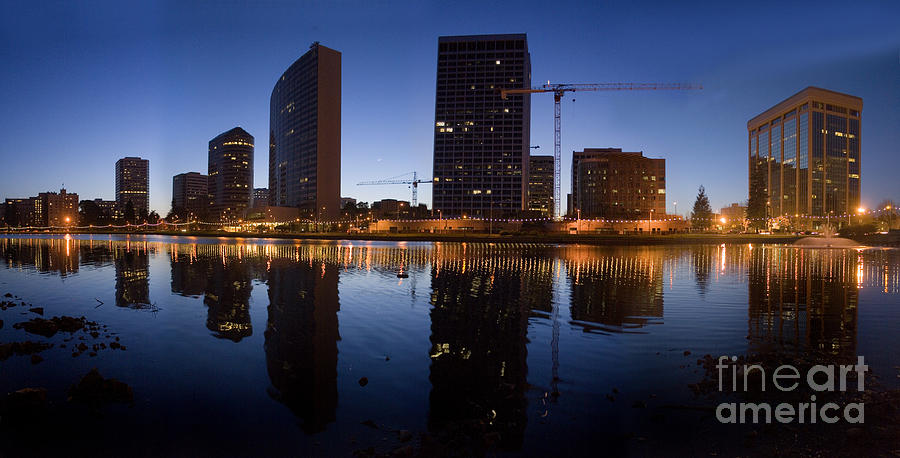 Lake Merritt in calm reflection of Downtown Oakland Photograph by Wernher Krutein