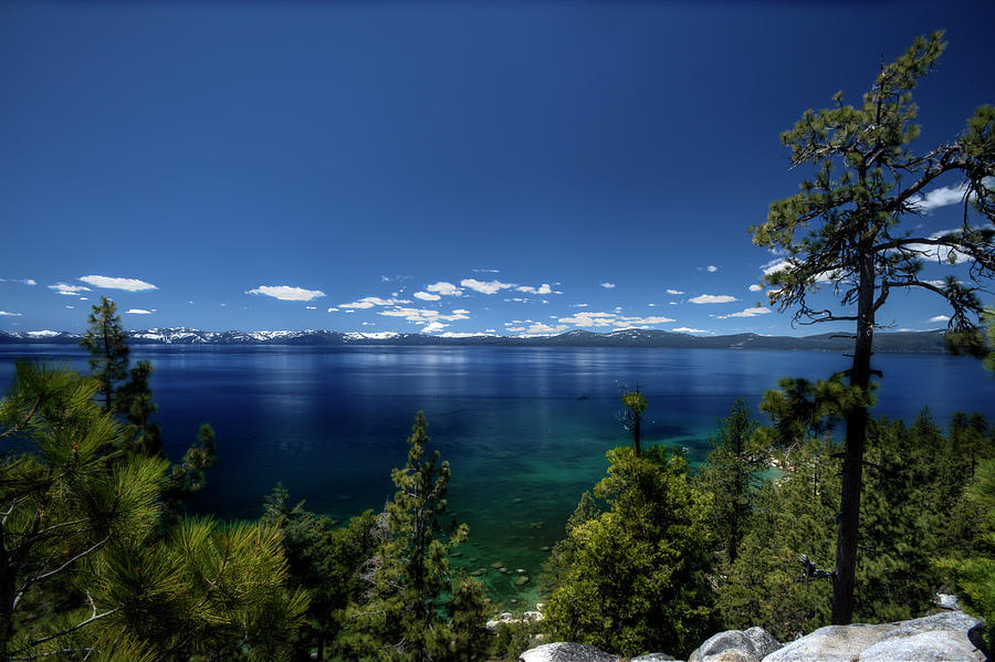 Lake Tahoe scene with puffy clouds and snow on mountains Photograph by Dan Friend
