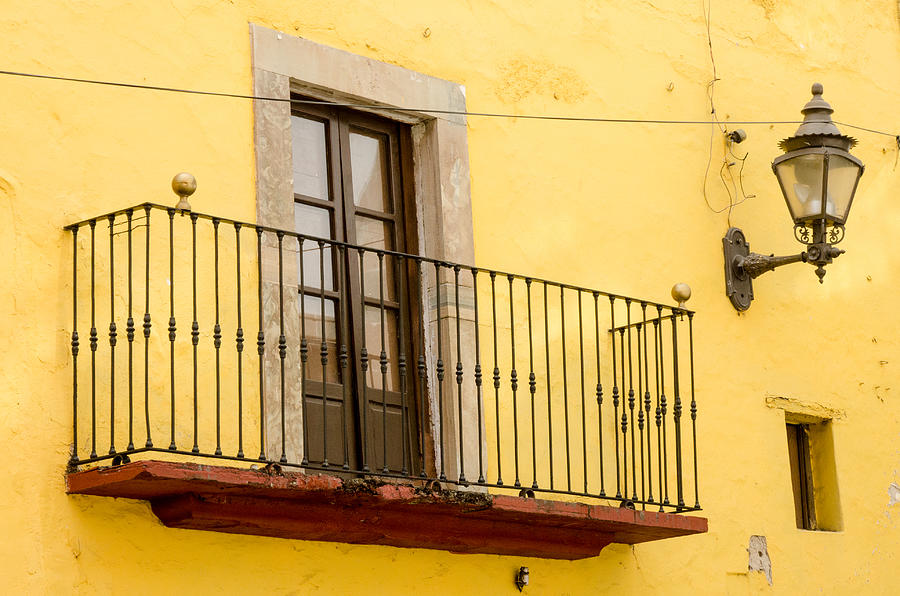 Lamp and Balcony on Yellow Stucco Wall Photograph by Rob Huntley