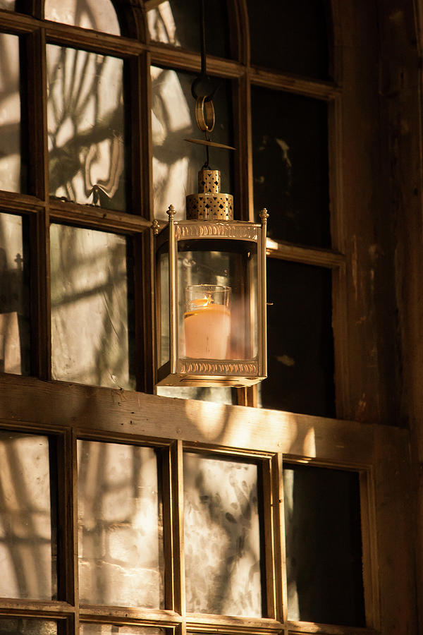 Lantern in a window  Photograph by Jason Hughes