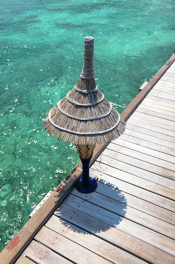 Lantern on Wooden Jetty over Blue Water Photograph by Jenny Rainbow