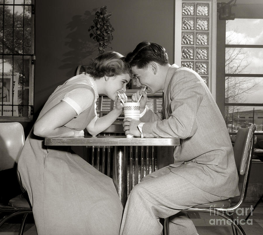 Laughing Couple Sharing A Drink Photograph by H. Armstrong Roberts/ClassicStock