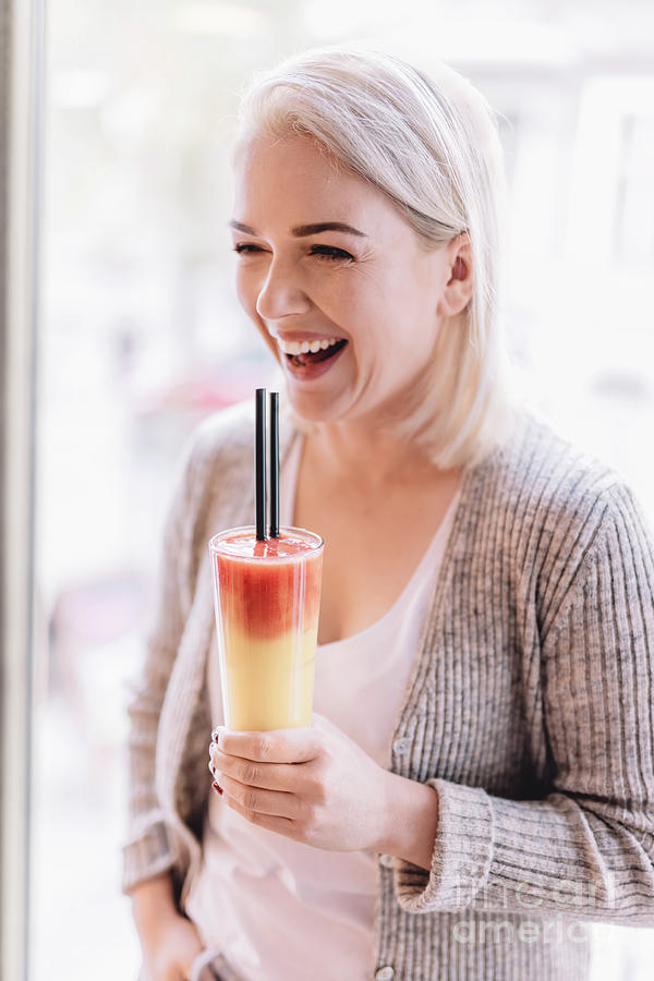 Laughing woman with a colorful beverage Photograph by Michal Bednarek