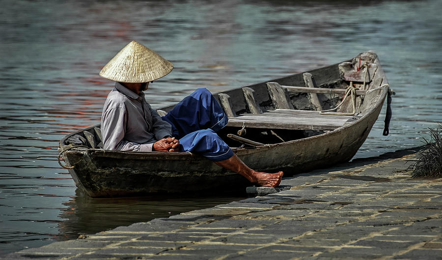 Fisherman lazing away-Hoi An Photograph by Usha Peddamatham
