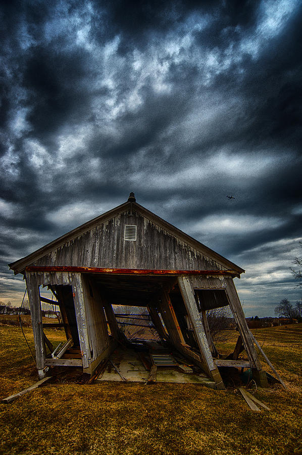 Leaning Building Under A Stormy Sky Photograph by Dick Pratt