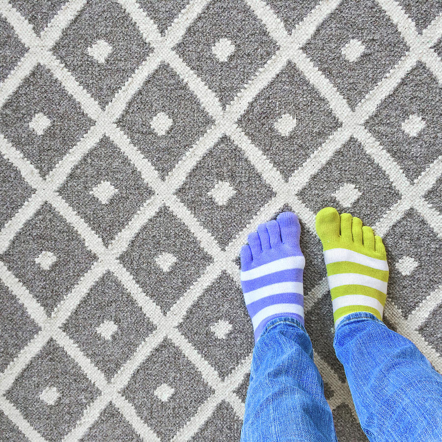Clothing Photograph - Legs in mismatched socks on gray carpet by GoodMood Art