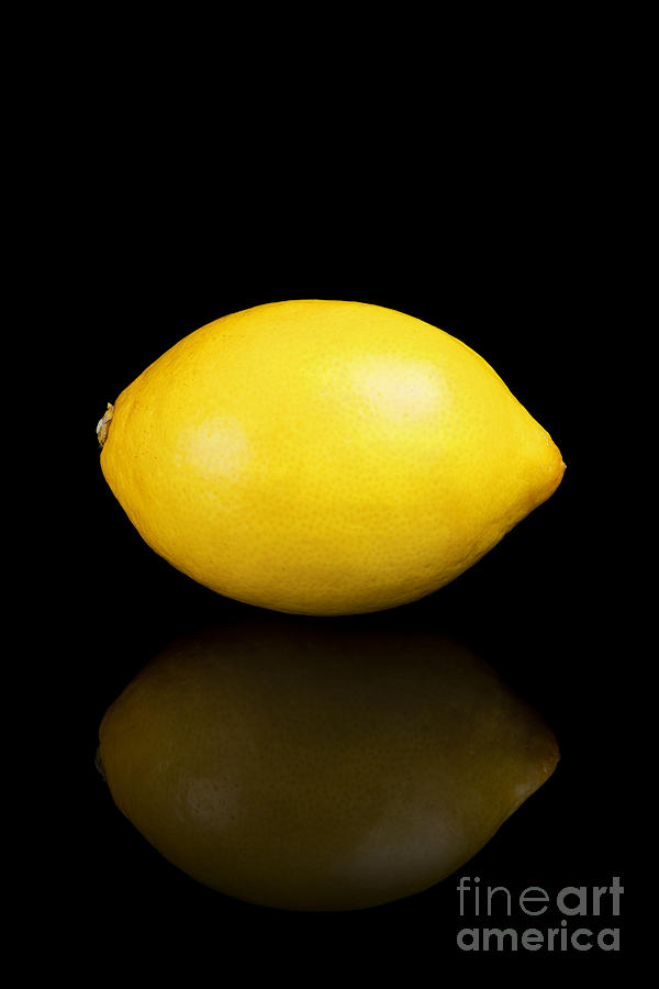 Lemon Photograph - Lemon on a black reflective background by Sara Winter