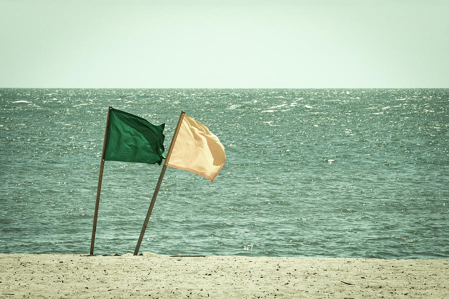Lifeguard Flags on a windy day at the beach - Faded Retro Film Look Photograph by Kyle Lee