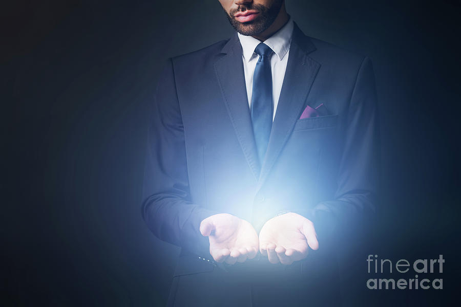 Light radiating from businessman hands Photograph by Michal Bednarek