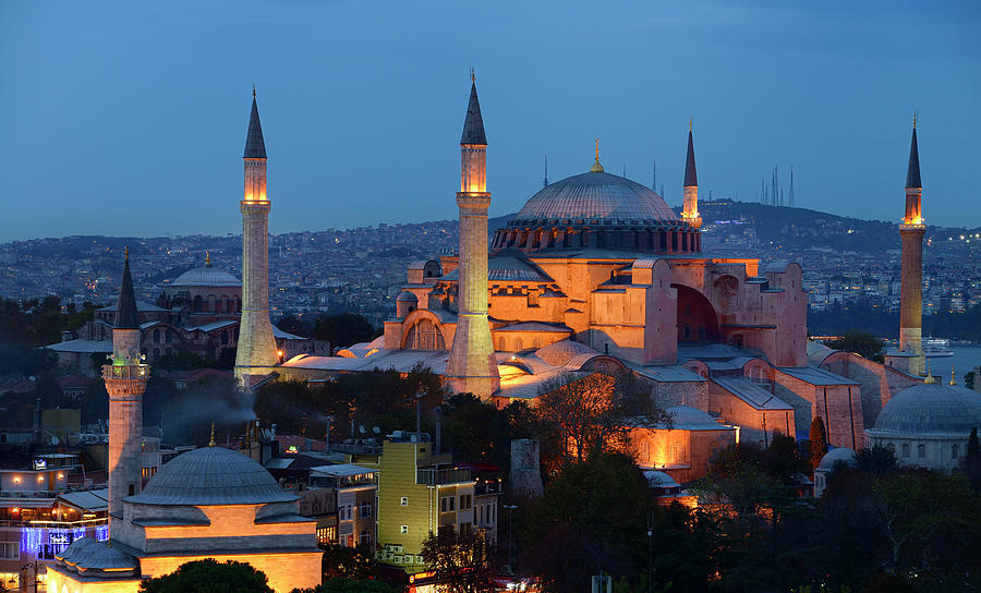 Lights on Hagia Sophia and Firuz Aga Mosque at dusk in Istanbul ...