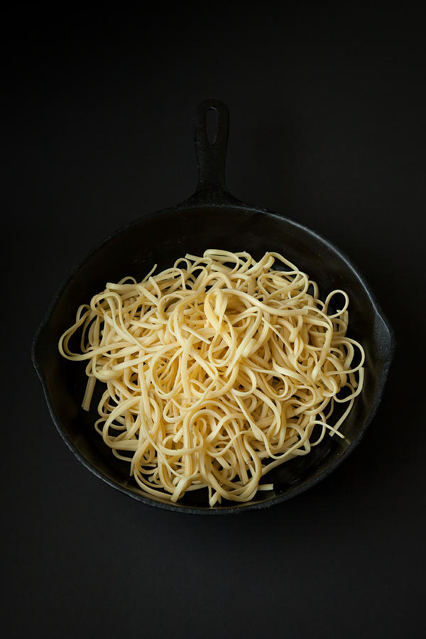 Linguine in a Cast Iron Pan with Black Background Photograph by Erin Cadigan
