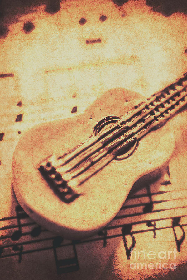 Little carved guitar on sheet music Photograph by Jorgo Photography