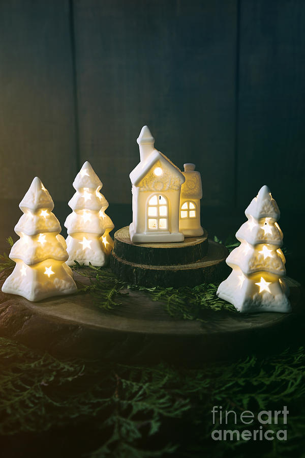 Little ceramic houses with lights and cedar branches Photograph by Sandra Cunningham