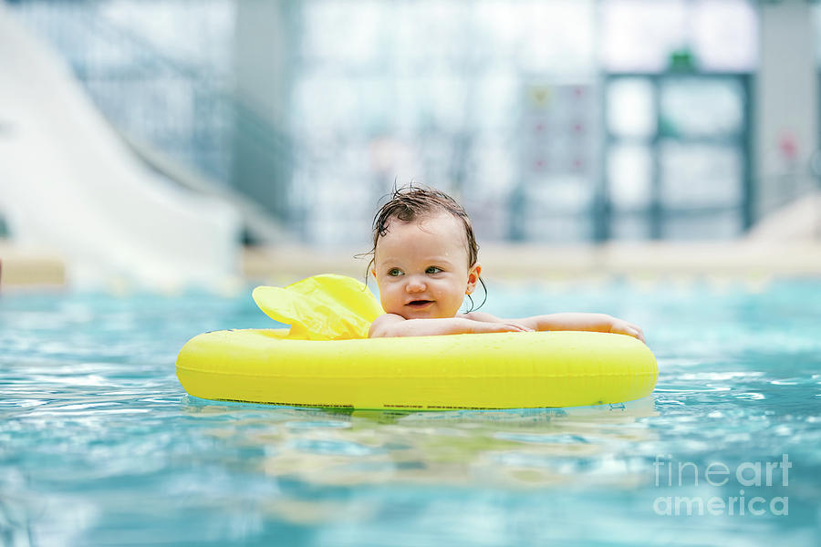 Little cute toddler swimming in a swim ring Photograph by Michal Bednarek