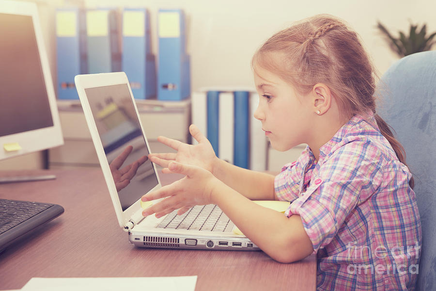 Little girl doing homework on the laptop Photograph by Anna Om