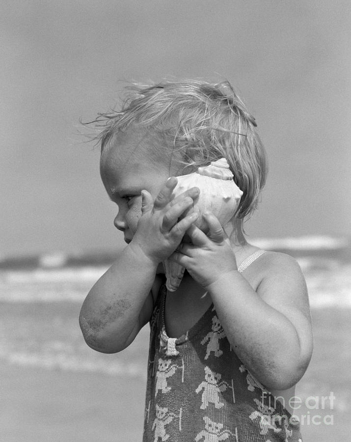 Little Girl Listening To Seashell Photograph by H Armstrong Roberts and ClassicStock