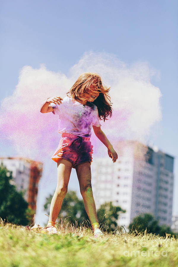 Little girl playing in colorful clouds of holi powder Photograph by Michal Bednarek