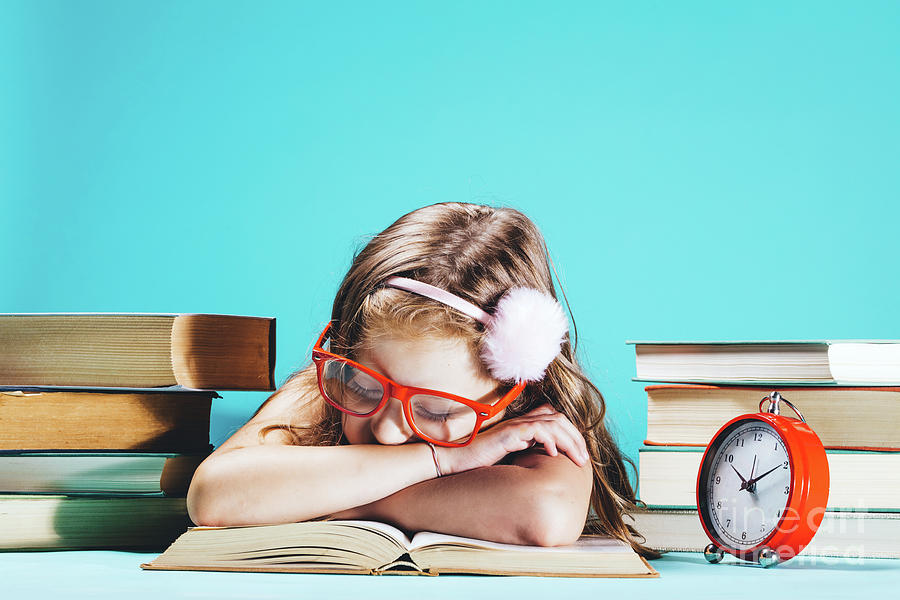 Little girl sleeping on an open book in funny red glasses Photograph by Michal Bednarek