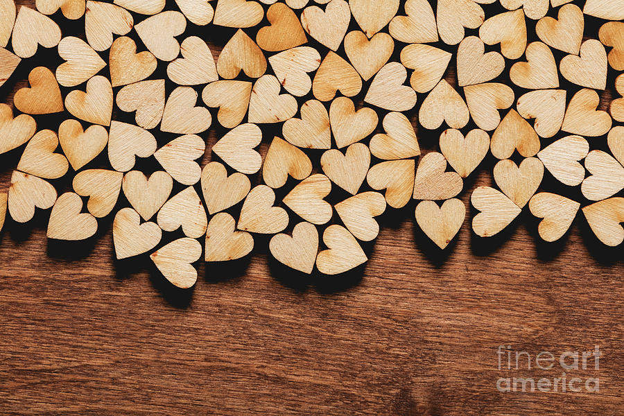 Little hearts on wooden background. Photograph by Michal Bednarek