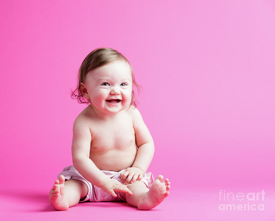 Little kid in a diaper sitting on a pink background Photograph by Michal Bednarek