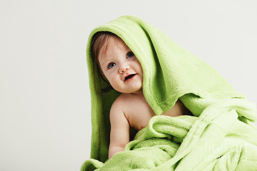 Little toddler covered in cozy blanket. Photograph by Michal Bednarek