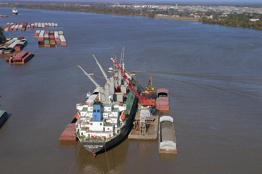 Loading barges from a ship in New Orleans Photograph by Garry McMichael