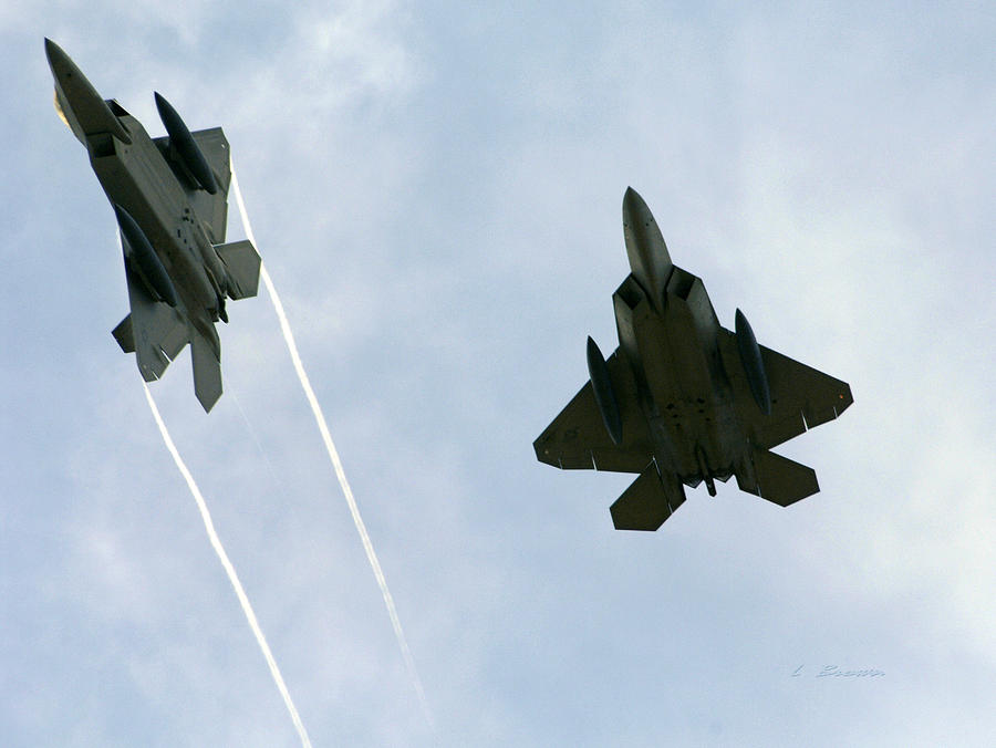 Airplane Photograph - Lockheed Martin F-22 Raptors Confronting Enemy Fighters by L Brown