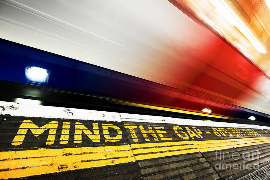 London Photograph - London underground. Mind the gap sign, train in motion by Michal Bednarek