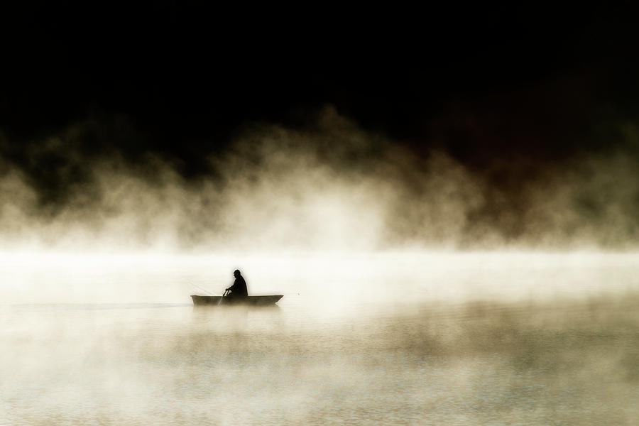 Lone fisherman on a lake Photograph by Dan Friend