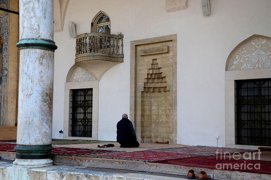 Lone Muslim man prays outdoors near mihrab at Sarajevo mosque  Bosnia Hercegovina Photograph by Imran Ahmed