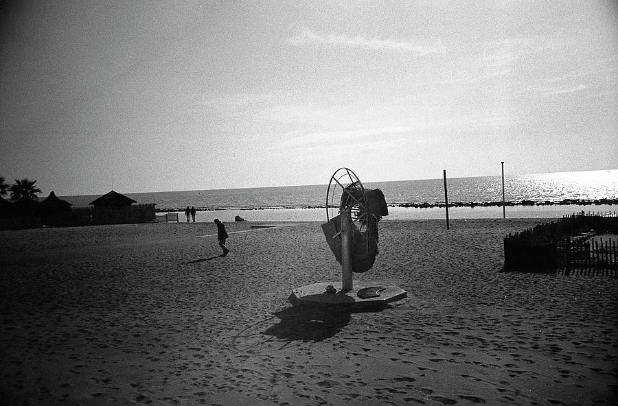 Ostia Photograph - Lonely man in Ostia Beach by Nacho Vega
