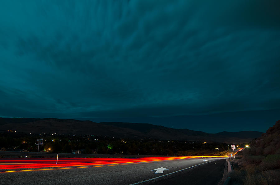 Long Vehicle Light Trails and Illuminated Highway Under A Teal Sky Filled With Long, Whispy Clouds Photograph by Brian Ball