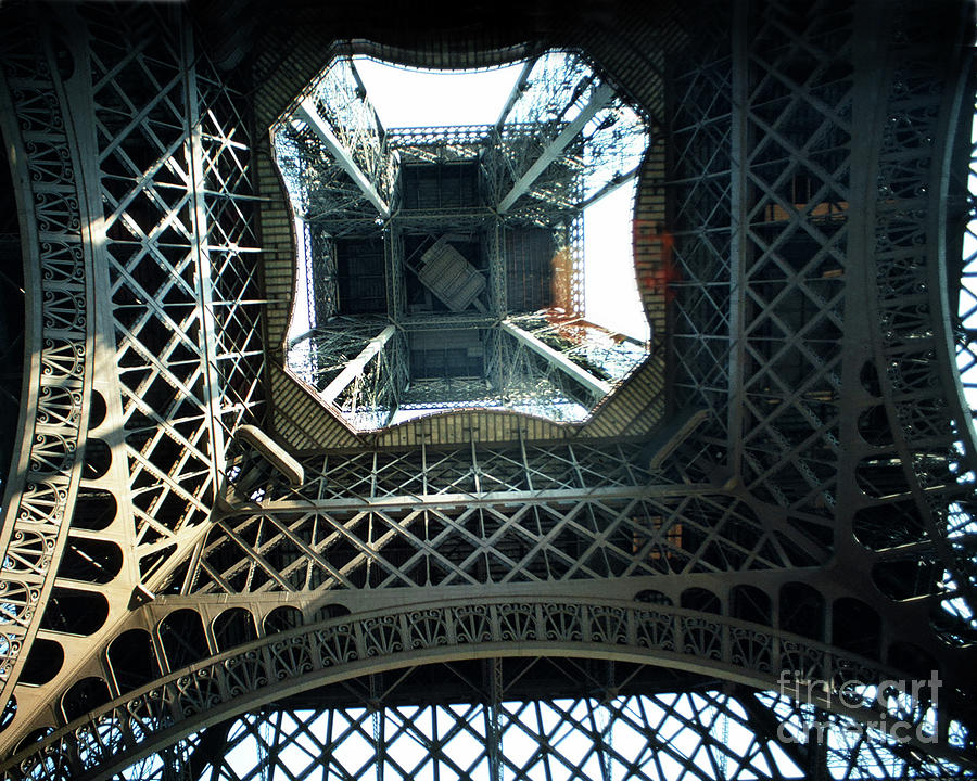 Eiffel Tower Photograph - Looking up from the center under the Eiffel Tower, Paris 1978 by Monterey County Historical Society