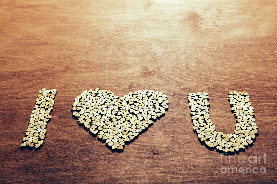 Love symbol made out of little wooden hearts Photograph by Michal Bednarek