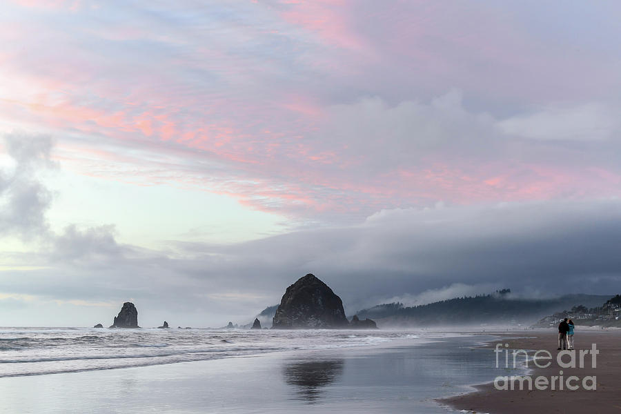 Watching the sunset at Haystack rock Photograph by Paul Quinn
