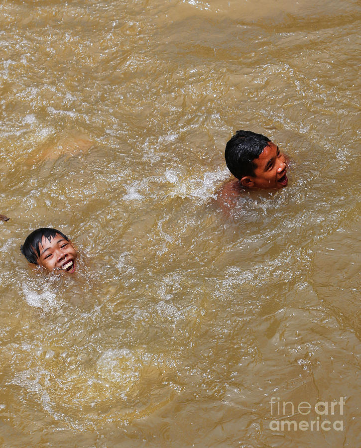 Landscape Photograph - Cambodian Boy Swimming in River  by Chuck Kuhn