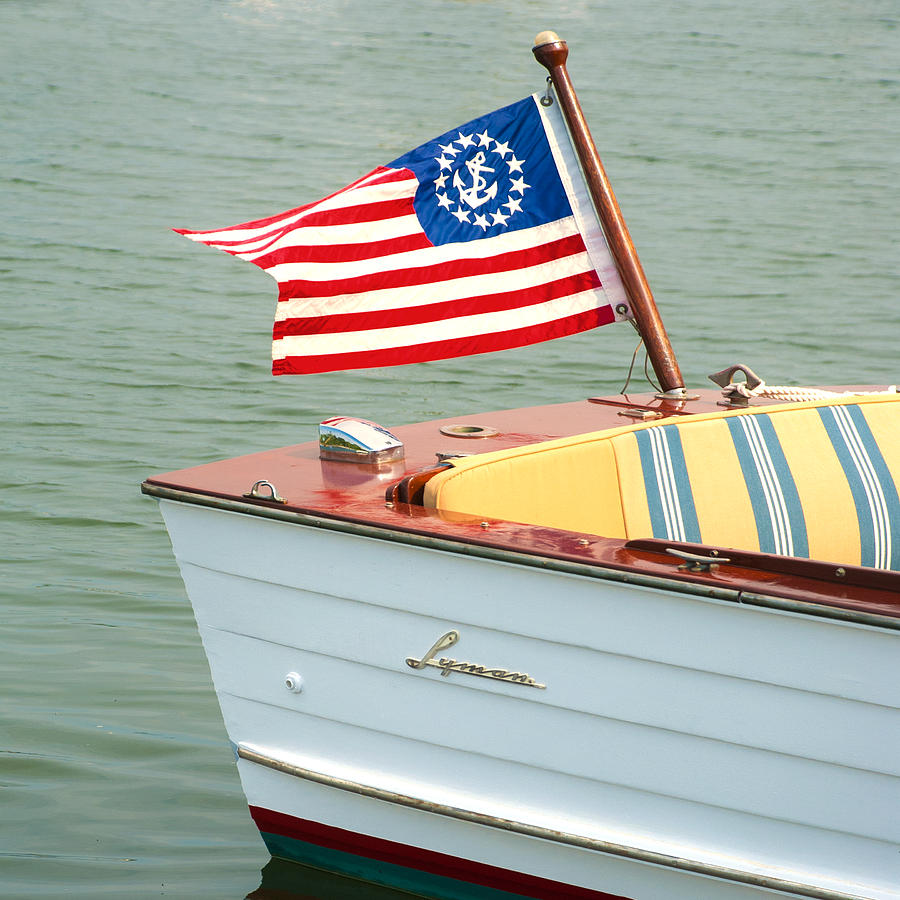 Vintage Mahogany Lyman Runabout Boat with Navy Flag Photograph by Charles Harden