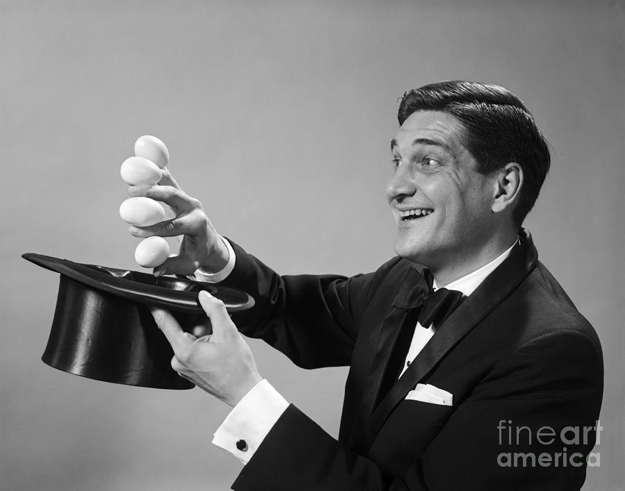 Magician Pulling Eggs Out Of Hat Photograph by H. Armstrong Roberts/ClassicStock