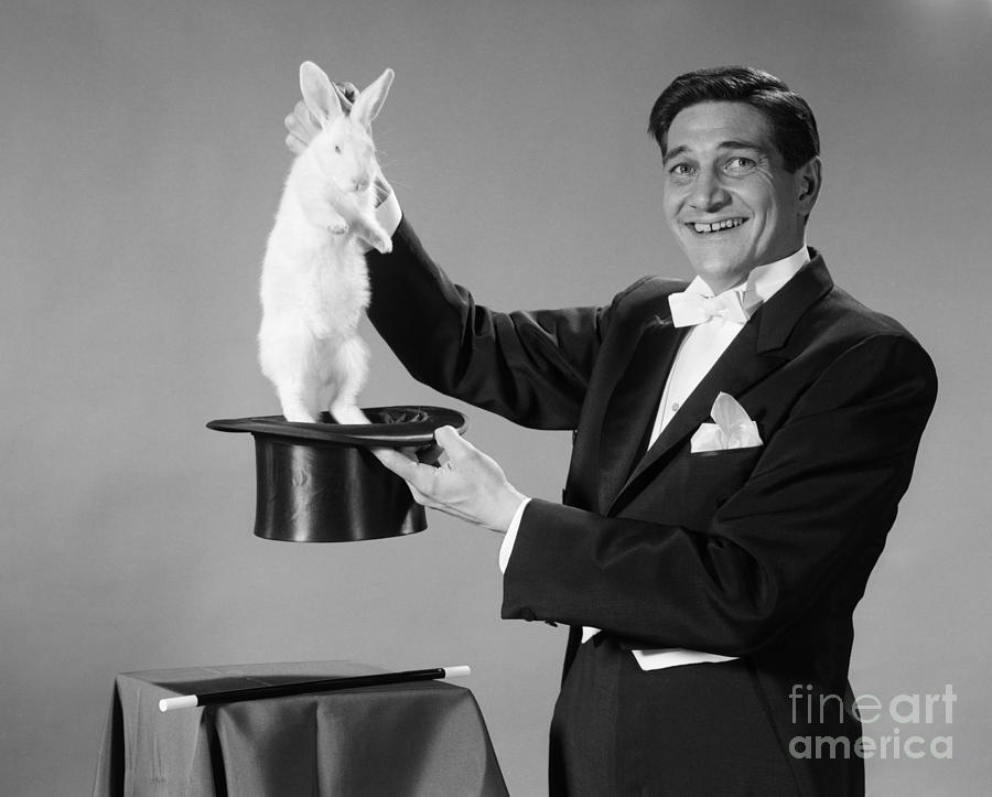 Magician Pulling Rabbit Out Of Hat Photograph by H. Armstrong Roberts/ClassicStock - Fine Art America
