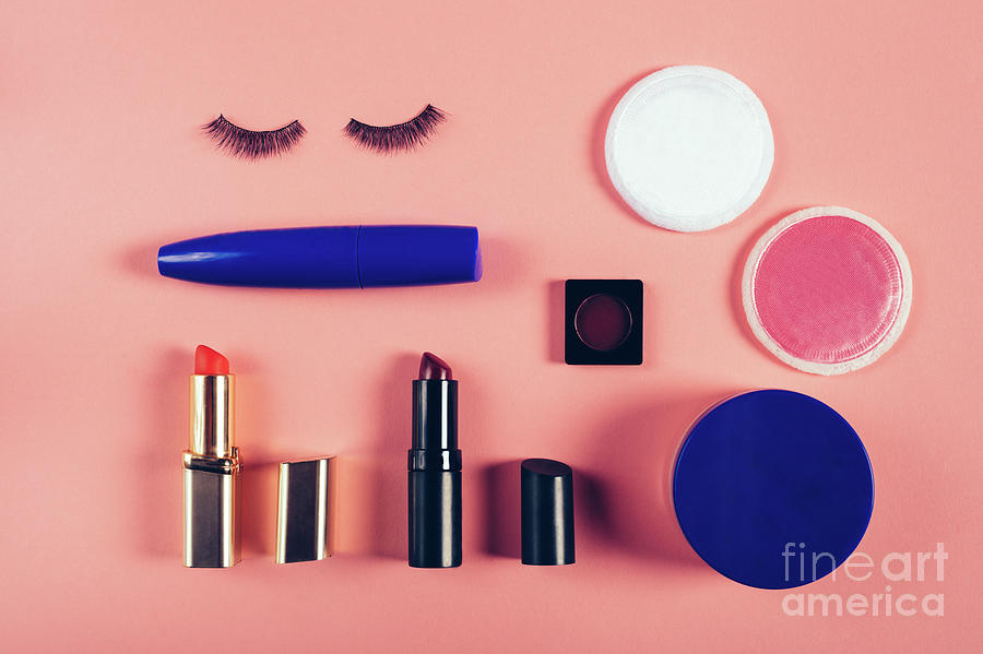 Make up supplies in a composition on a pink background. Photograph by Michal Bednarek