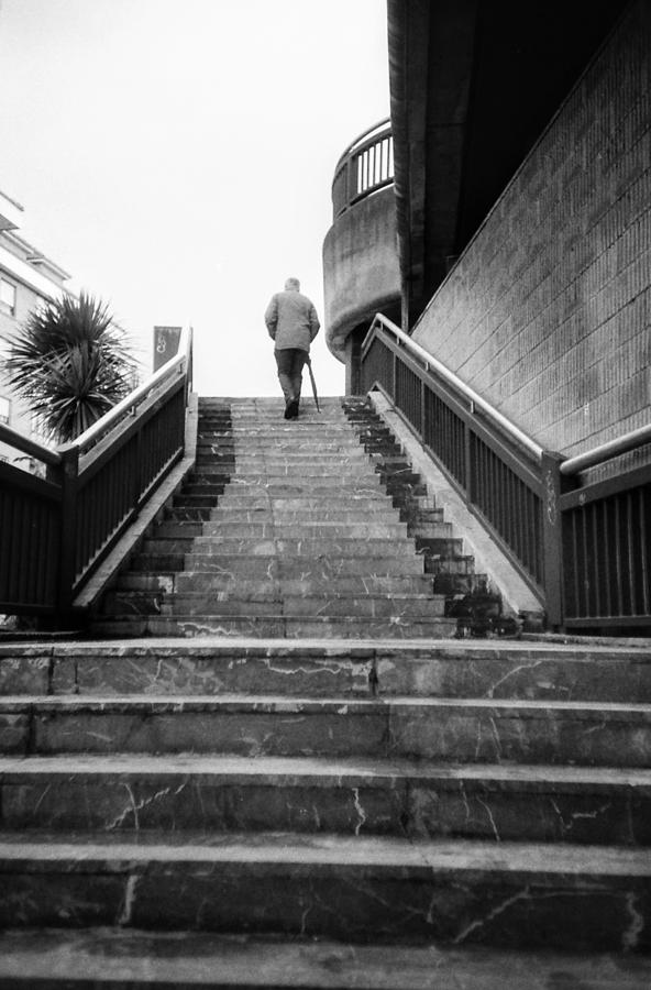 Black And White Photograph - Man and stairs by Nacho Vega